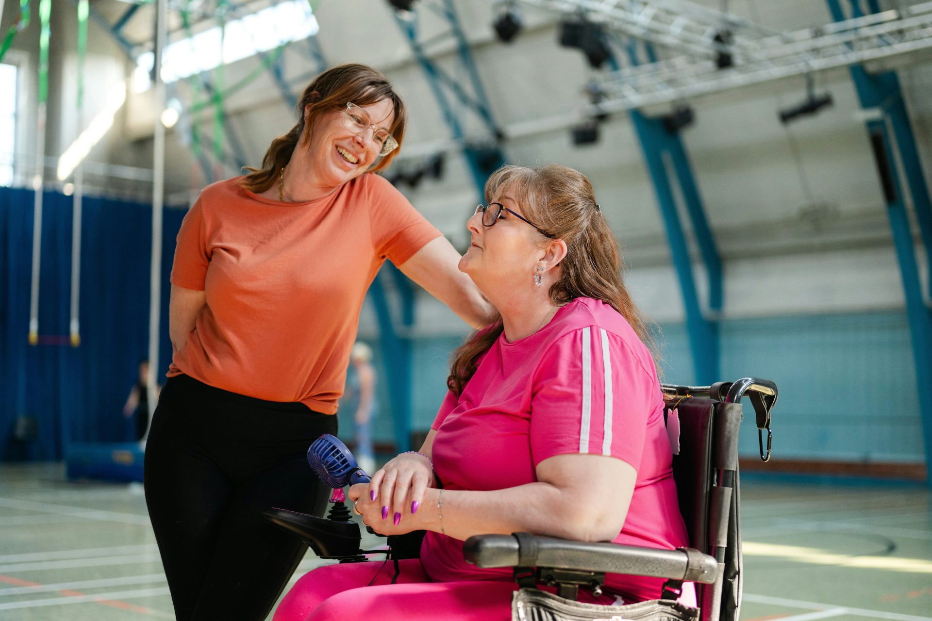 Two women talking in a gymnasium